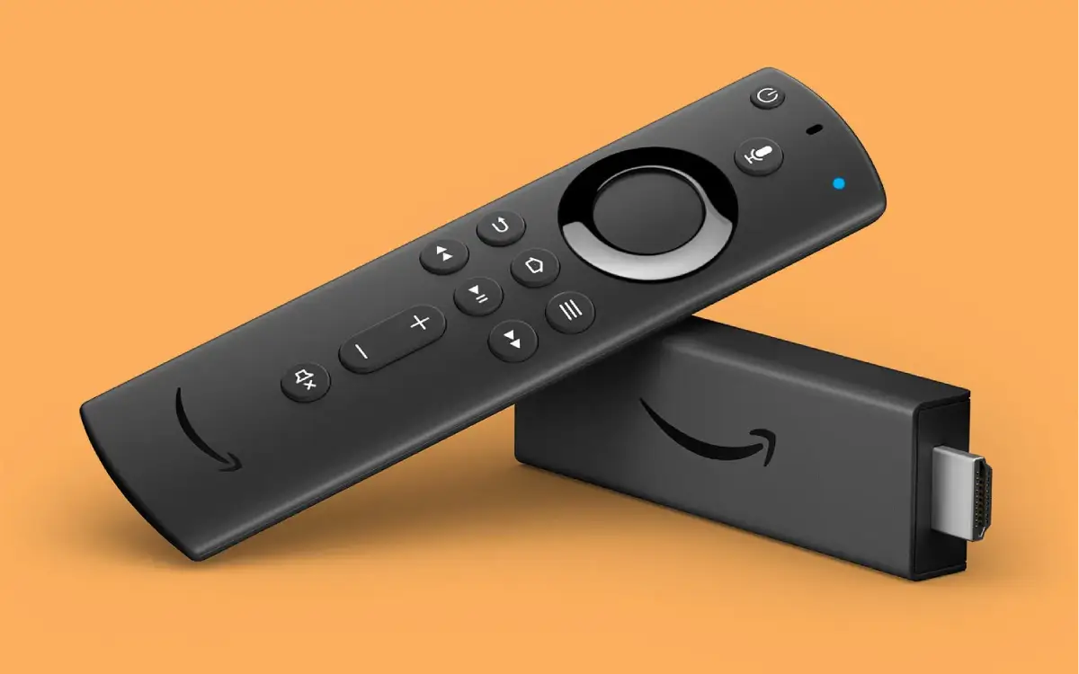 A person holding an Amazon Firestick remote with a TV in the background
